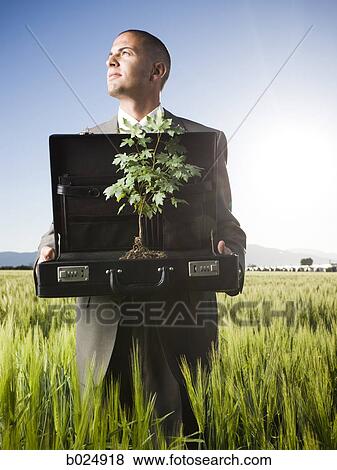 businessman holding a briefcase with a tree in it View Large Photo Image Stock Photo - businessman holding a briefcase with a tree in it. Fotosearch
