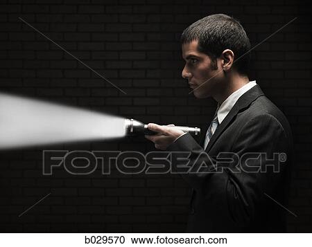 businessman holding a flashlight View Large Photo Image Stock Image - businessman holding a flashlight. Fotosearch