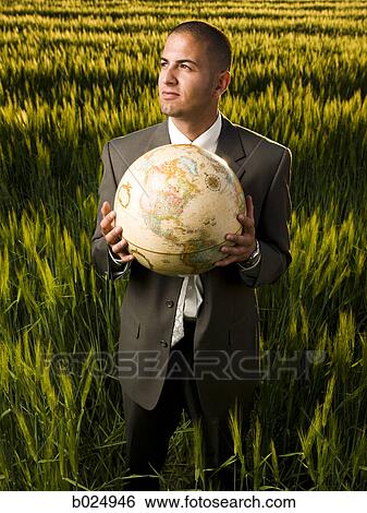 businessman holding a globe View Large Photo Image Stock Photograph - businessman holding a globe. Fotosearch