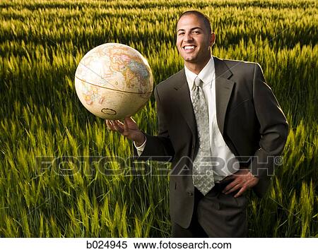Stock Photography - businessman holding a globe. Fotosearch