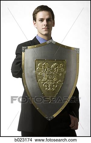 businessman holding a shield View Large Photo Image Picture - businessman holding a shield. Fotosearch