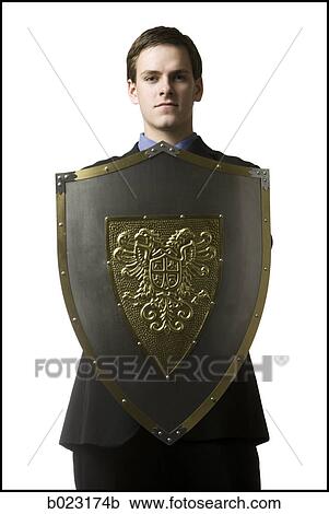 Stock Image - businessman holding a shield. Fotosearch