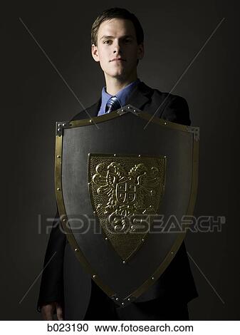 businessman holding a shield View Large Photo Image Stock Image - businessman holding a shield. Fotosearch