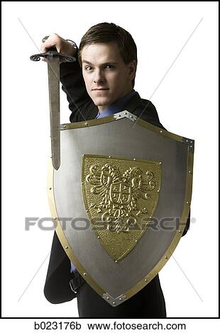 businessman holding a sword and shield View Large Photo Image Stock Image - businessman holding a sword and shield. Fotosearch