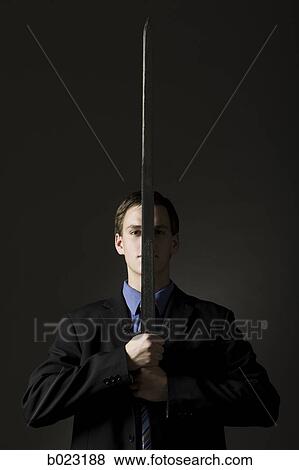 businessman holding a sword View Large Photo Image Stock Photo - businessman holding a sword. Fotosearch