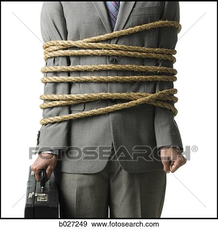 businessman in a full suit tied up with a rope around his mid section View Large Photo Image Stock Photo - businessman in a full suit tied up with a rope around his mid section. Fotosearch