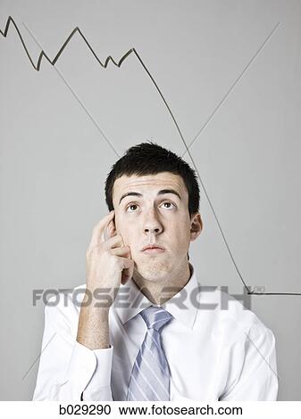 businessman looking at a declining graph View Large Photo Image Stock Image - businessman looking at a declining graph. Fotosearch