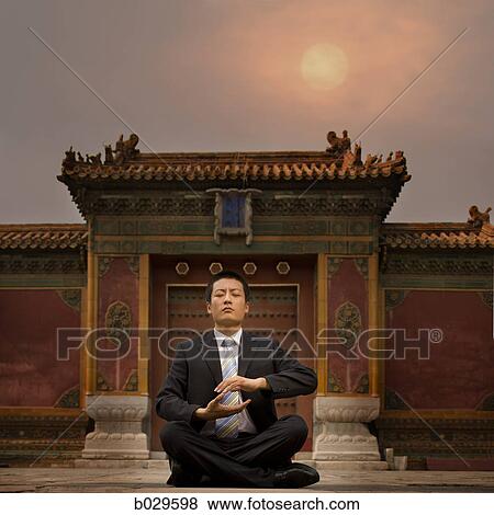 Stock Photo - businessman sitting in front of a chinese style building. Fotosearch