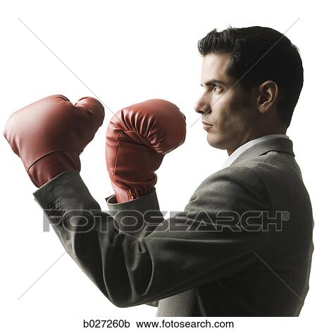 Stock Image - businessman wearing boxing gloves. Fotosearch