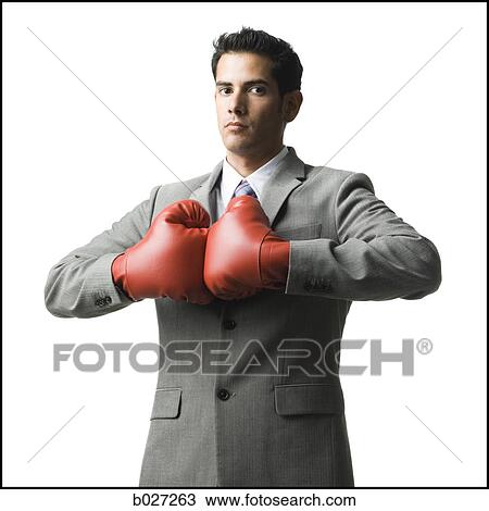 Stock Image - businessman wearing boxing gloves. Fotosearch
