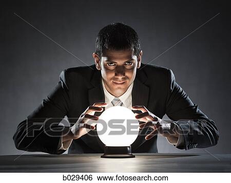 Stock Photograph - businessman with a crystal ball. Fotosearch