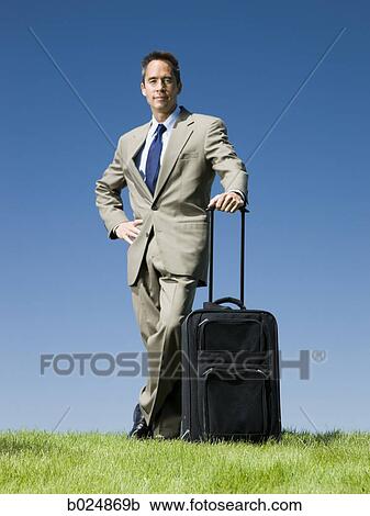 businessman with a rolling suitcase View Large Photo Image Stock Image - businessman with a rolling suitcase. Fotosearch