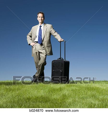 businessman with a rolling suitcase View Large Photo Image Stock Image - businessman with a rolling suitcase. Fotosearch
