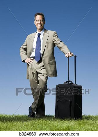 businessman with a rolling suitcase View Large Photo Image Stock Photo - businessman with a rolling suitcase. Fotosearch