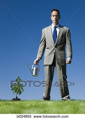 businessman with a watering can View Large Photo Image Stock Photography - businessman with a watering can. Fotosearch