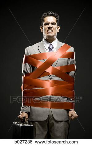 businessman wrapped up with red tape View Large Photo Image Stock Photograph - businessman wrapped up with red tape. Fotosearch