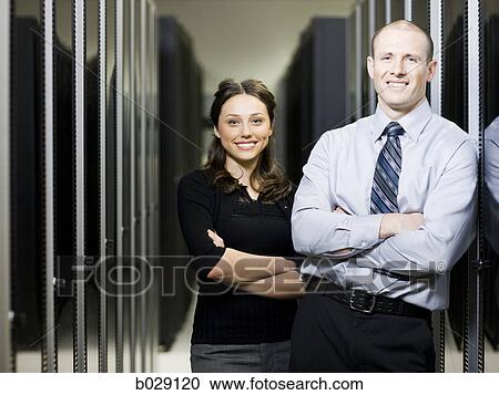 businesspeople standing in a server room with their arms folded View Large Photo Image Stock Image - businesspeople standing in a server room with their arms folded. Fotosearch