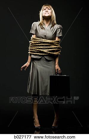 businesswoman all tied up with ropes View Large Photo Image Stock Photo - businesswoman all tied up with ropes. Fotosearch