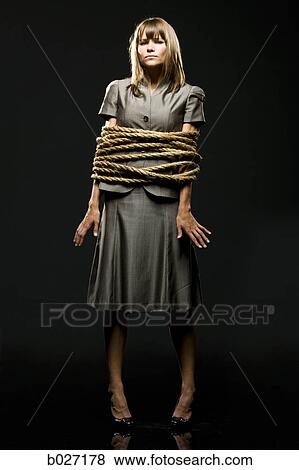 businesswoman all tied up with ropes View Large Photo Image Stock Photo - businesswoman all tied up with ropes. Fotosearch