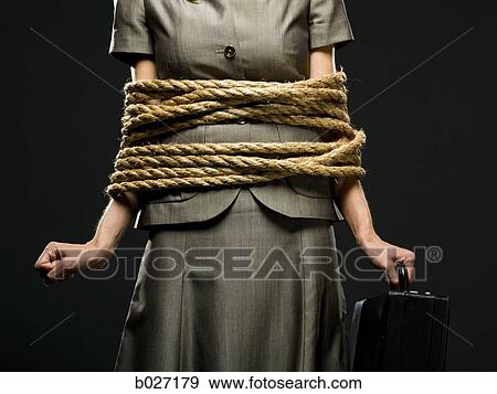 businesswoman all tied up with ropes View Large Photo Image Stock Photo - businesswoman all tied up with ropes. Fotosearch