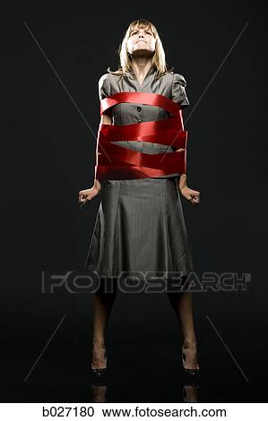 businesswoman all wrapped up in red ribbon View Large Photo Image Stock Image - businesswoman all wrapped up in red ribbon. Fotosearch