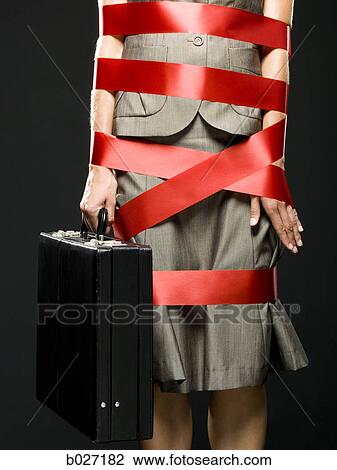 businesswoman all wrapped up in red ribbon View Large Photo Image Stock Image - businesswoman all wrapped up in red ribbon. Fotosearch