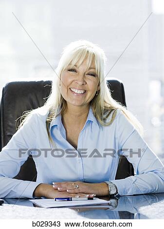 businesswoman at her desk View Large Photo Image Stock Image - businesswoman at her desk. Fotosearch