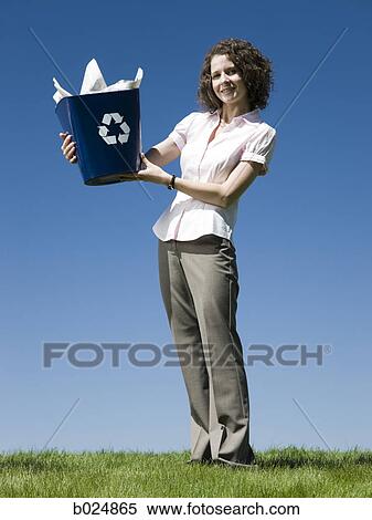 Stock Photography - businesswoman holding a recycling bin. Fotosearch