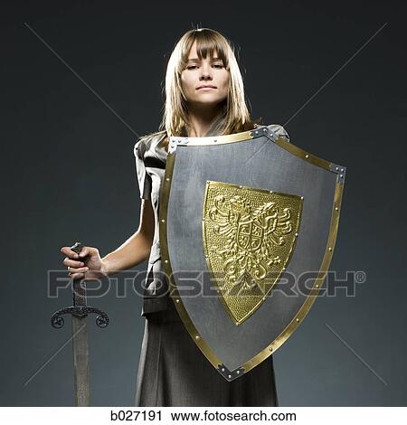 businesswoman holding a sword and a shield View Large Photo Image Stock Image - businesswoman holding a sword and a shield. Fotosearch