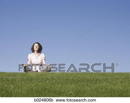 businesswoman meditating on the grass View Large Photo Image Stock Image - businesswoman meditating on the grass. Fotosearch
