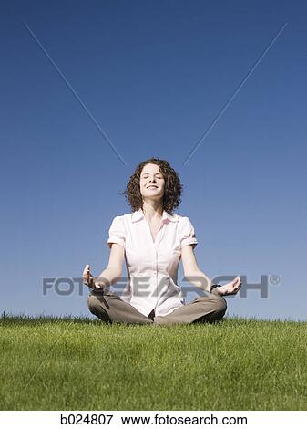 businesswoman meditating on the grass View Large Photo Image Stock Photo - businesswoman meditating on the grass. Fotosearch