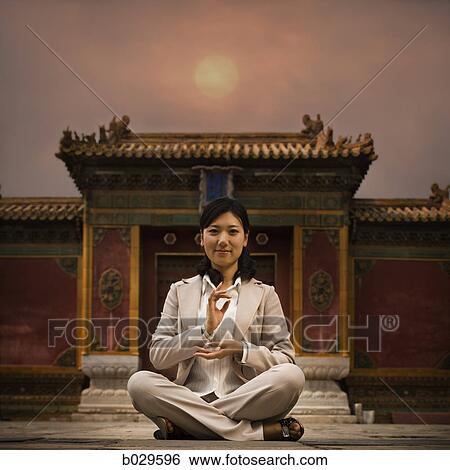 businesswoman sitting in front of a chinese style building View Large Photo Image Stock Photograph - businesswoman sitting in front of a chinese style building. Fotosearch