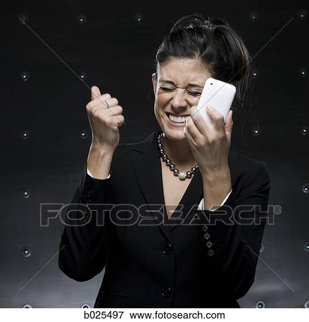 Stock Photo - businesswoman using a cell phone. Fotosearch