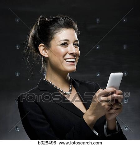 businesswoman using a cell phone View Large Photo Image Stock Photograph - businesswoman using a cell phone. Fotosearch