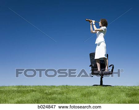 businesswoman using a spyglass telescope View Large Photo Image Stock Photo - businesswoman using a spyglass telescope. Fotosearch