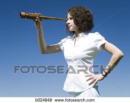 businesswoman using a spyglass telescope View Large Photo Image Stock Photo - businesswoman using a spyglass telescope. Fotosearch
