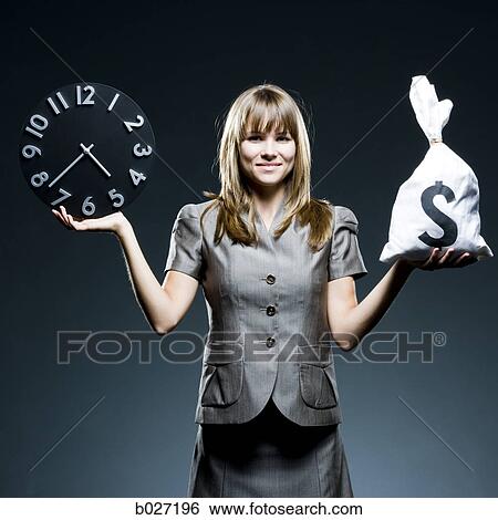 businesswoman weighing time versus money View Large Photo Image Stock Photograph - businesswoman weighing time versus money. Fotosearch