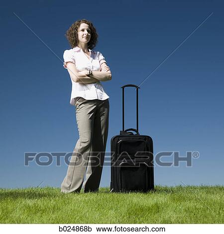 businesswoman with a rolling suitcase View Large Photo Image Stock Image - businesswoman with a rolling suitcase. Fotosearch