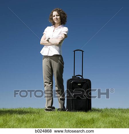 businesswoman with a rolling suitcase View Large Photo Image Stock Photo - businesswoman with a rolling suitcase. Fotosearch