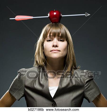 businesswoman with an apple with an arrow through it on her head View Large Photo Image Stock Image - businesswoman with an apple with an arrow through it on her head. Fotosearch
