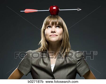 businesswoman with an apple with an arrow through it on her head View Large Photo Image Stock Image - businesswoman with an apple with an arrow through it on her head. Fotosearch