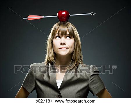 businesswoman with an apple with an arrow through it on her head View Large Photo Image Stock Photo - businesswoman with an apple with an arrow through it on her head. Fotosearch