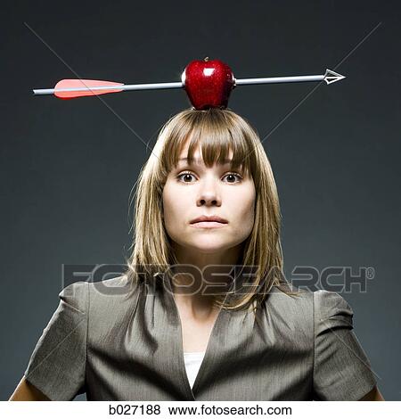businesswoman with an apple with an arrow through it on her head View Large Photo Image Stock Photo - businesswoman with an apple with an arrow through it on her head. Fotosearch