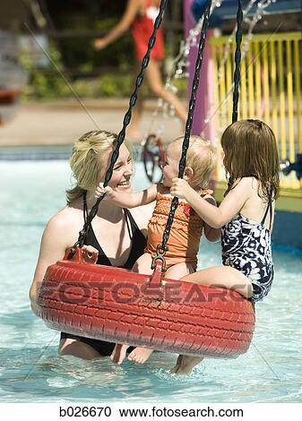 Stock Image - children on a tire swing at a waterpark. Fotosearch