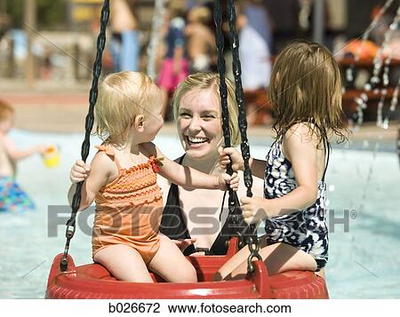 Stock Image - children on a tire swing at a waterpark. Fotosearch