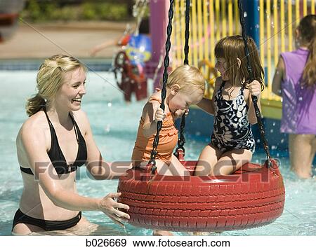 children on a tire swing at a waterpark View Large Photo Image Stock Photo - children on a tire swing at a waterpark. Fotosearch