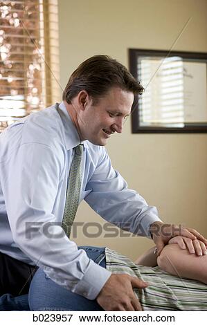 chiropractor treating a patient View Large Photo Image Stock Photo - chiropractor treating a patient. Fotosearch