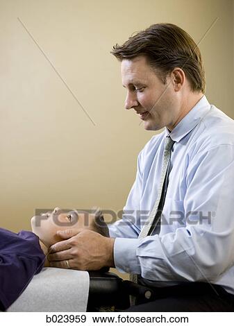 chiropractor treating a patient View Large Photo Image Stock Photo - chiropractor treating a patient. Fotosearch