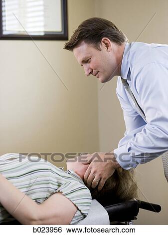 chiropractor treating a patient View Large Photo Image Stock Photograph - chiropractor treating a patient. Fotosearch