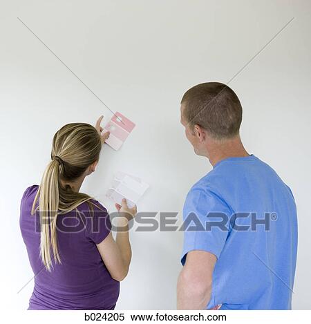 couple choosing a color to paint a room View Large Photo Image Stock Photography - couple choosing a color to paint a room. Fotosearch